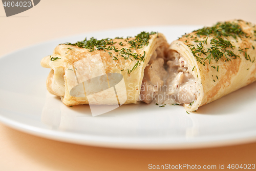 Image of Close-up rolled pancake with filling from chicken and mushroom.