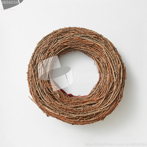 Image of Handmade round wreath from twigs on a white