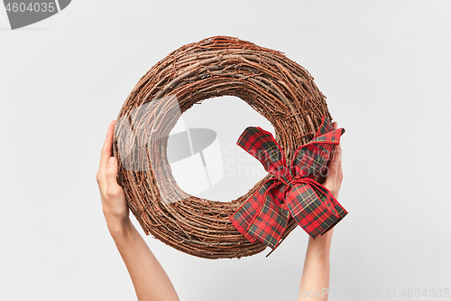 Image of Handcraft round wreath from twigs in the woman\'s hands.