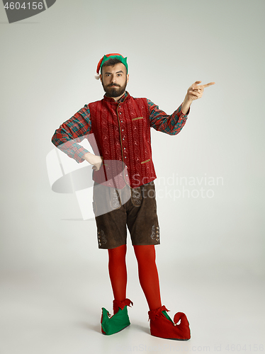 Image of friendly man dressed like a funny gnome posing on an isolated gray background