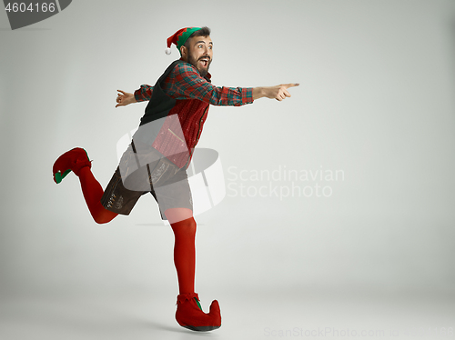 Image of friendly man dressed like a funny gnome posing on an isolated gray background