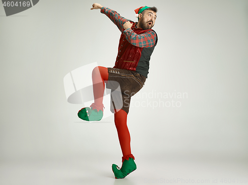 Image of friendly man dressed like a funny gnome posing on an isolated gray background