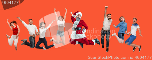 Image of Freedom in moving. young man and women jumping against red background