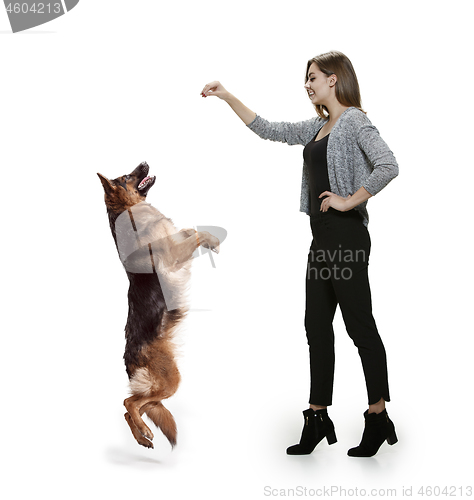 Image of Woman with her dog over white background