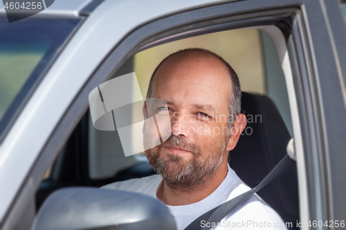 Image of bearded man sitting in his car