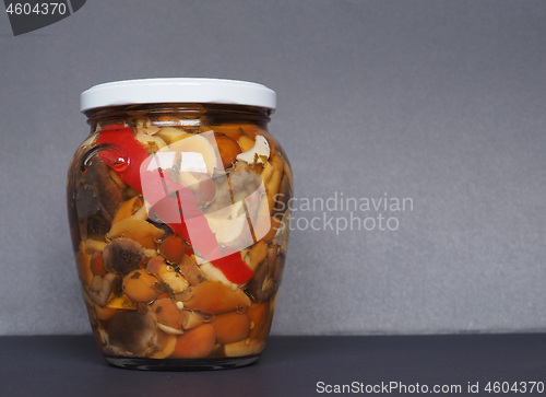 Image of mixed champignons and porcini mushrooms in jar