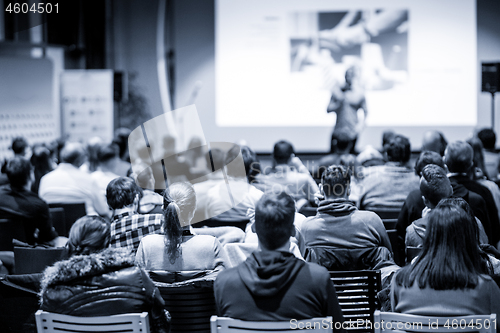 Image of Male public peaker giving presentation on business conference event.