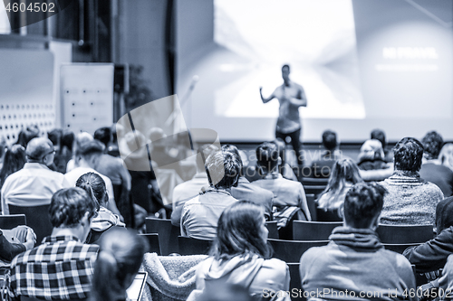 Image of Male public peaker giving presentation on business conference event.