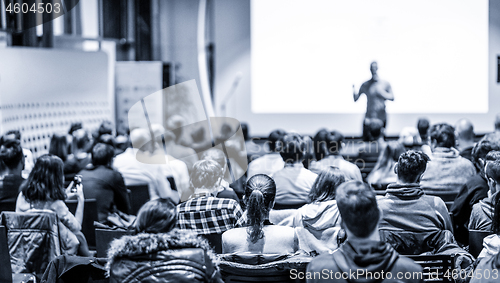 Image of Male public peaker giving presentation on business conference event.