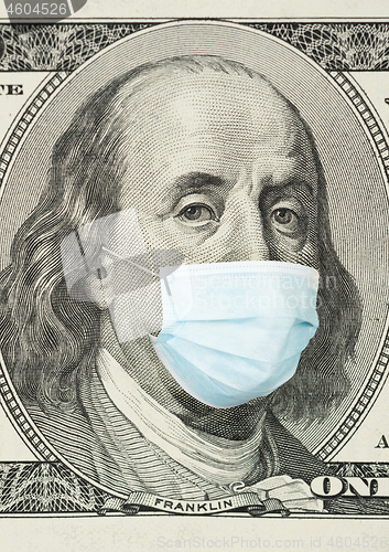 Image of 100 dollar banknote with medical mask.