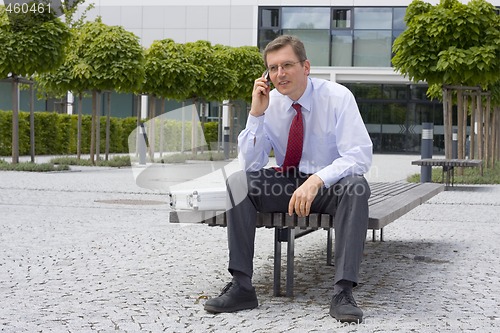 Image of Businessman talking on mobile phone