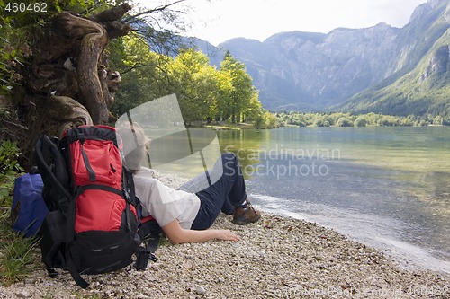 Image of Female hiker resting at a mountain lake