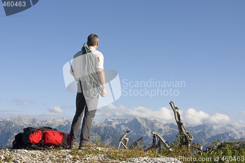 Image of Mountaineer with rope on mountain peak