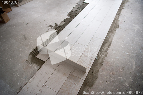 Image of Ceramic wood effect tiles and tools for tiler on the floor