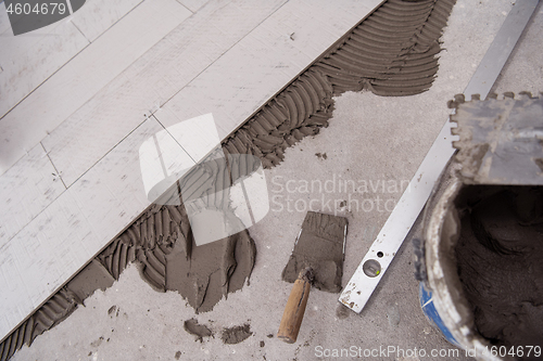 Image of Ceramic wood effect tiles and tools for tiler on the floor