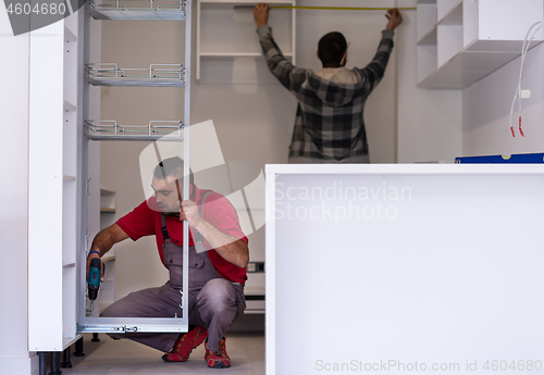 Image of workers installing a new kitchen