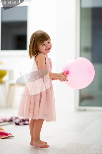 Image of cute little girl playing with balloons