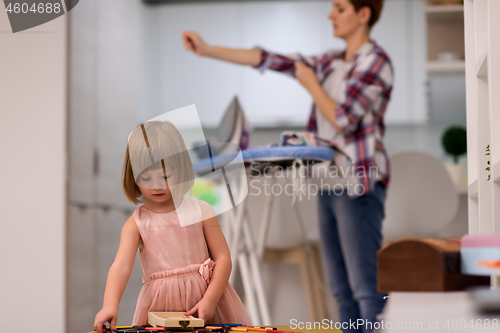 Image of mother and daughter spending time together at home