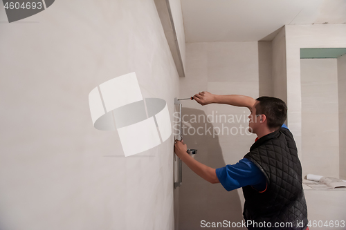 Image of professional plumber working in a bathroom