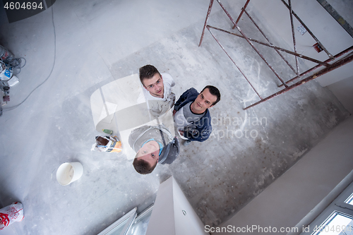 Image of top view of Workers and builders with dirty uniform in apartment