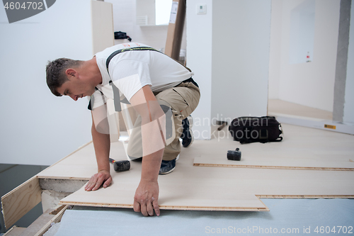 Image of Worker Installing New Laminated Wooden Floor