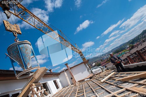 Image of Construction worker installing a new roof