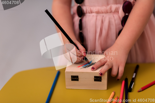 Image of little girl painting jewelry box