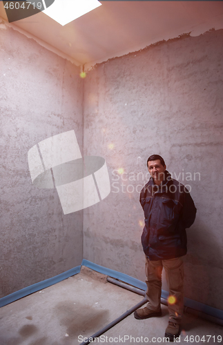 Image of Portrait of construction engineer in unfinished apartment