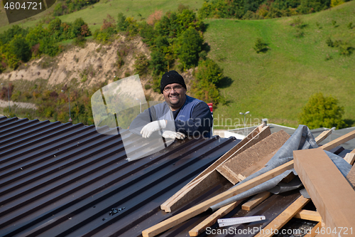 Image of Construction worker installing a new roof