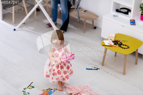 Image of mother and little daughter spending time together at home