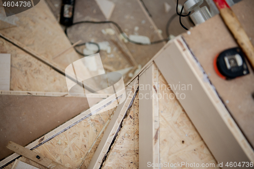 Image of work in progress on stylish interior with wooden stairs