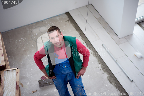 Image of worker installing the ceramic wood effect tiles on the floor