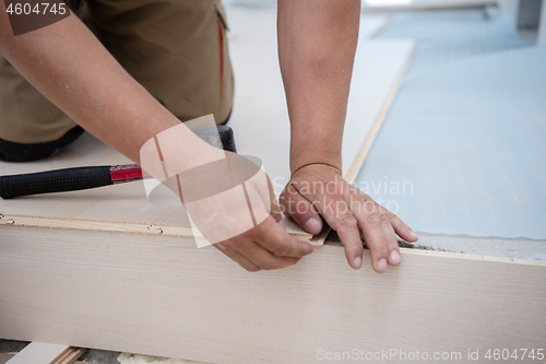 Image of Worker Installing New Laminated Wooden Floor