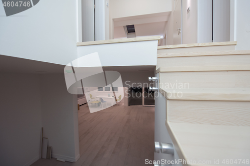 Image of stylish interior with wooden stairs