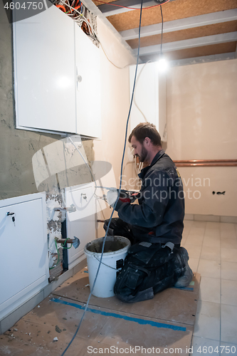 Image of Worker plastering the wall by concrete