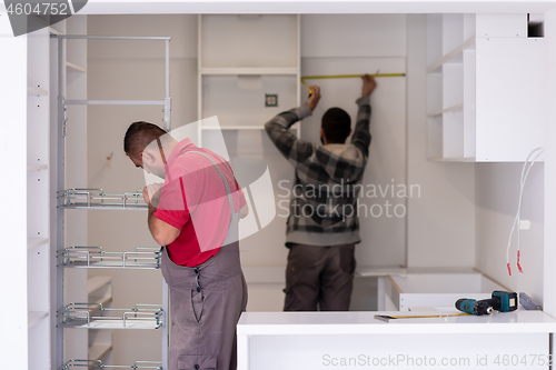 Image of workers installing a new kitchen