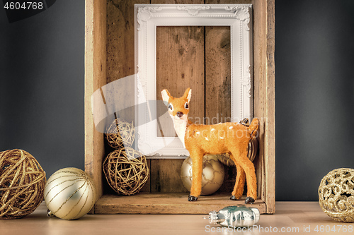Image of Christmas decoration wooden box with deer golden balls and a whi