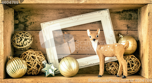 Image of Christmas decoration wooden box with deer golden balls and a whi