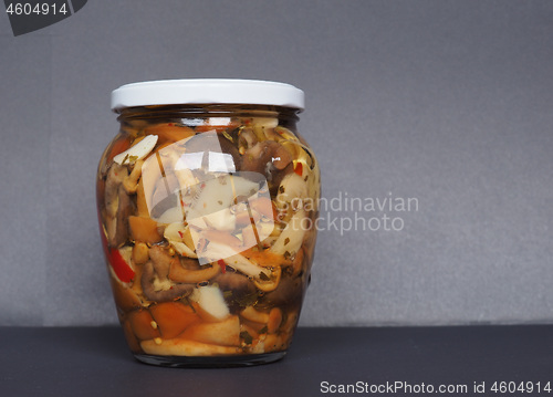 Image of mixed champignons and porcini mushrooms in jar