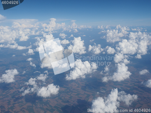 Image of blue sky with clouds background seen from flying plane