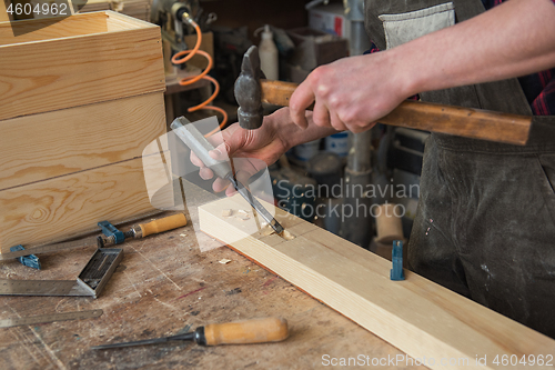 Image of Carpenter working with a chisel