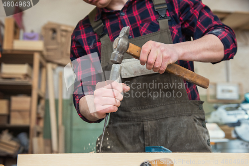 Image of Carpenter working with a chisel