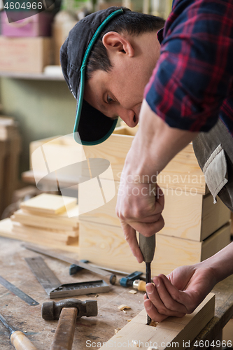 Image of Carpenter working with a chisel