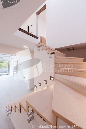 Image of stylish interior with wooden stairs