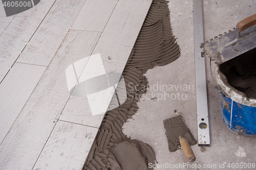 Image of Ceramic wood effect tiles and tools for tiler on the floor