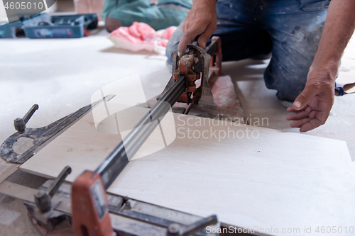 Image of worker cutting the ceramic wood effect tiles