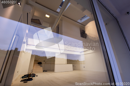 Image of outside view trough window on two level apartment interior