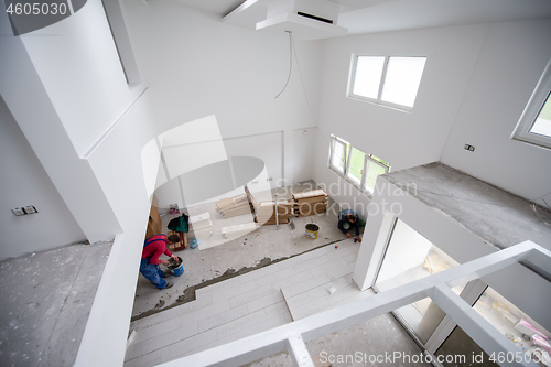 Image of worker installing the ceramic wood effect tiles on the floor