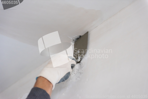 Image of construction worker plastering on gypsum walls