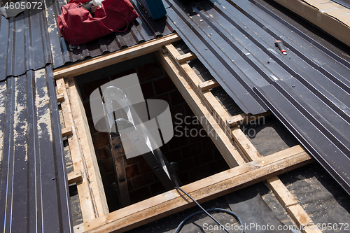 Image of Construction worker installing a new roof